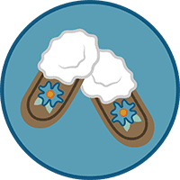 An icon in a blue circle. The icon is of a pair of fur lined moccasins with beadwork flowers on the top of the foot.