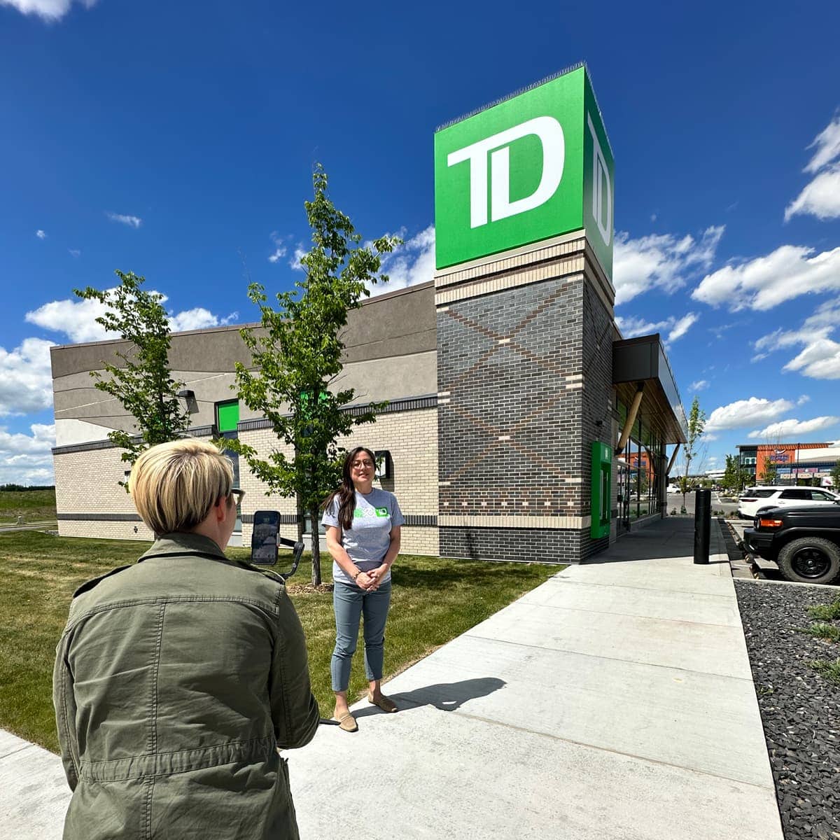 Filming an Indigenous TD Bank staff member outside of a brand in Calgary.