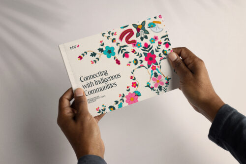 A pair of hands holding the book, Connecting with Indigenous Communities
